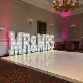 The stunning Crathorne Hall Hotel with one of our gloss white Led Starlit dance floors and our giant Led Mr & Mrs with blush pink uplighting.